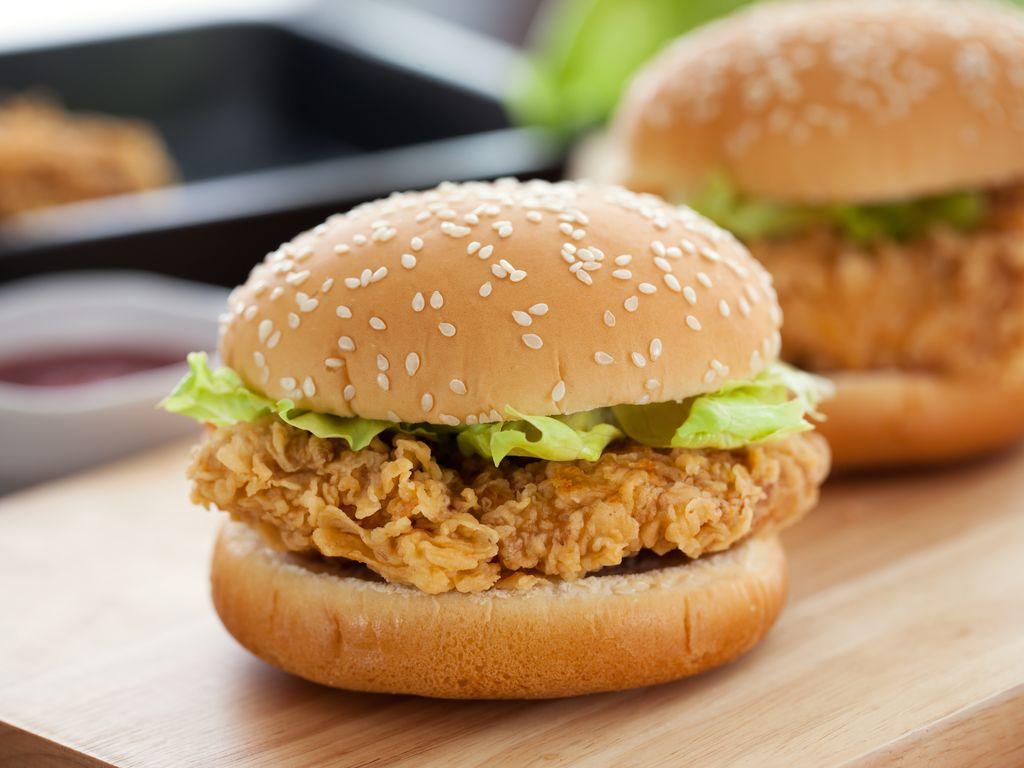 Un sandwich burger au poulet et laitue de KFC sur une table 